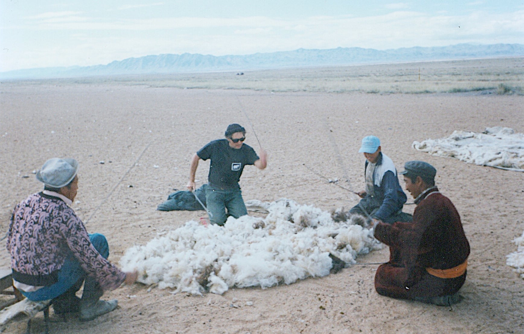 Buriat Jeff and family process the wool for felting by his Ail at Khar Us Nuur